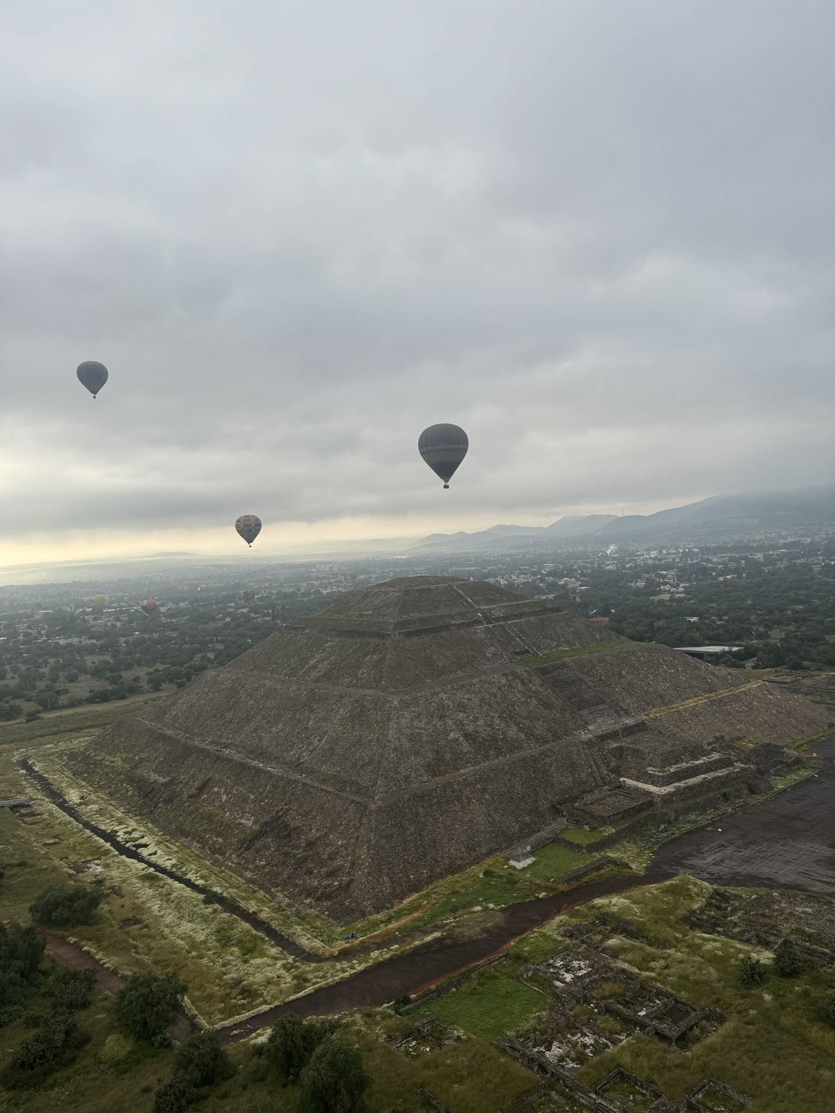 Hot-air balloons floating over the Pyramid of the Sun at Teotihuacán at dawn